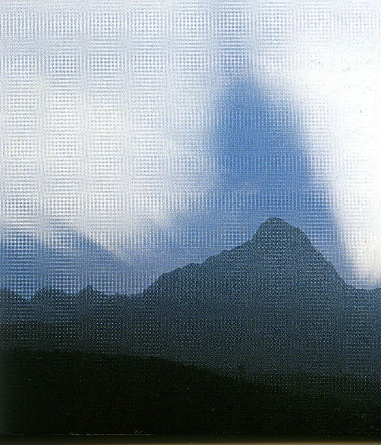 Pizzo Badile at the equinox dawn, with its ghostlike shadow in the sky